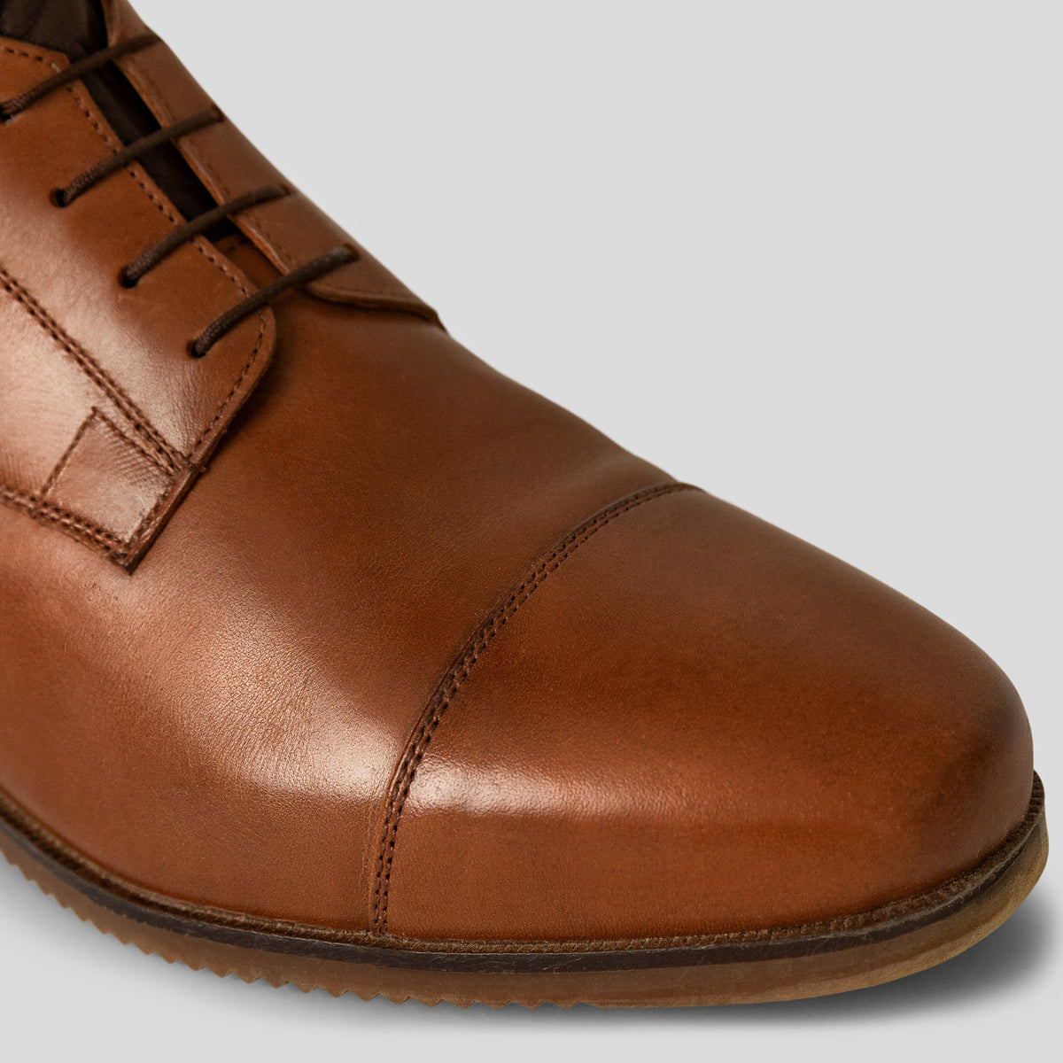 Detail of brown leather riding boots with elastic laces